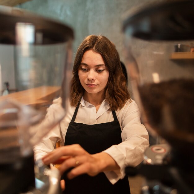 Woman in apron making coffee