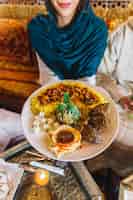 Foto gratuita donna e piatto arabo nel ristorante