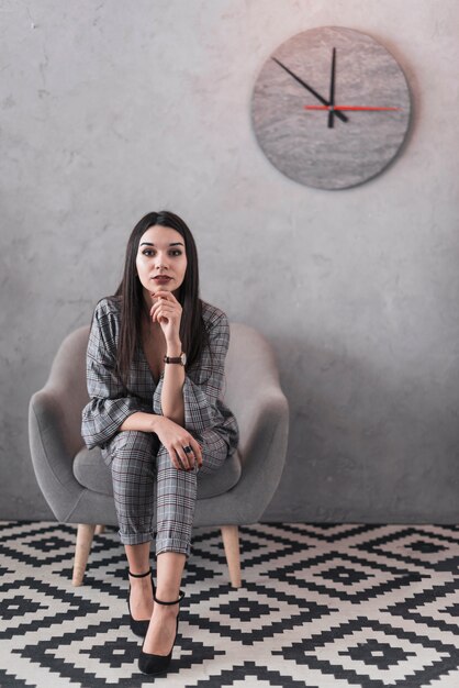 Woman in armchair looking at camera