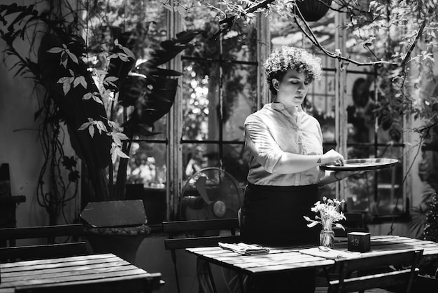 Woman arranging flowers in a greenhouse