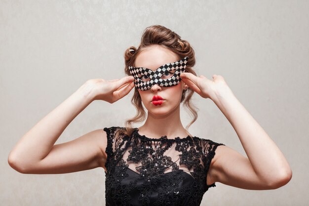 Woman arranging her mask front view