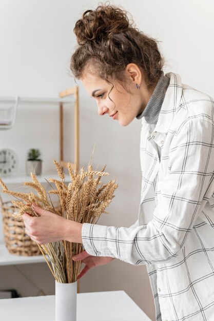 Woman arranging plants medium shot