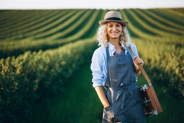 Woman artist painting with oil paints in a field