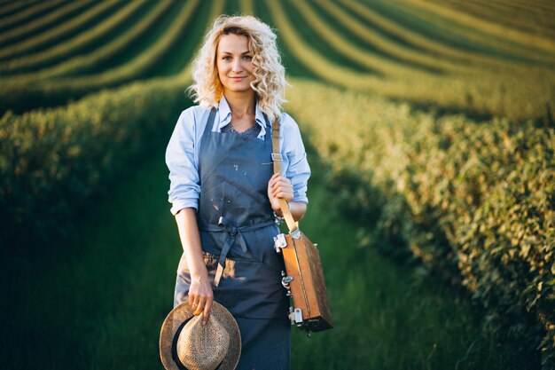 Woman artist painting with oil paints in a field