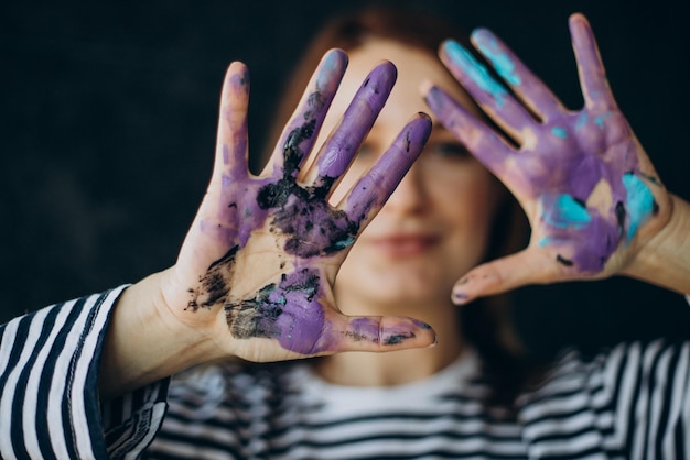 Woman artist with with painted hands