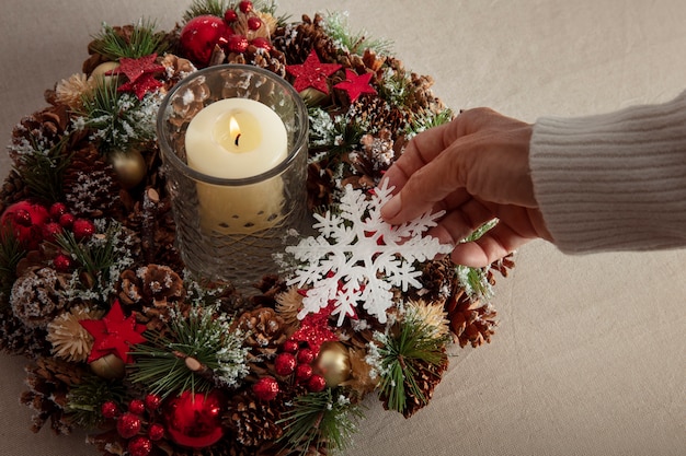 Free photo woman assembling holiday themed wreath