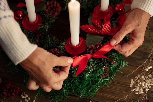 Free photo woman assembling holiday themed wreath