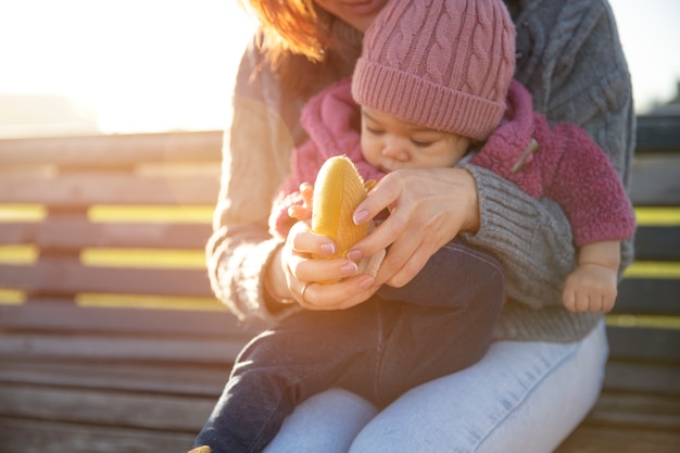 Woman and baby sitting on bench