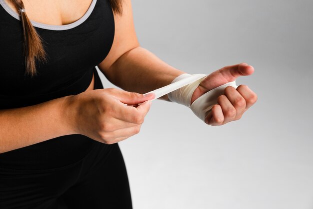 Woman bandaging her hands sideways