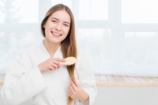 Foto gratuita donna in accappatoio a lavarsi i capelli