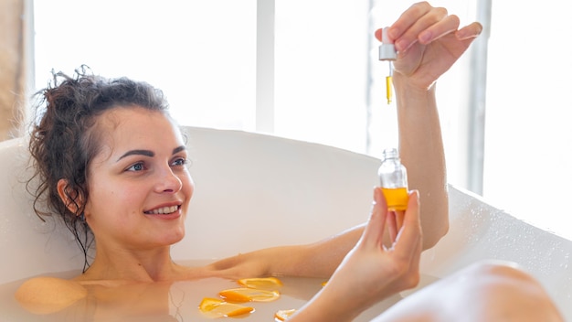 Woman in bathtub taking bath