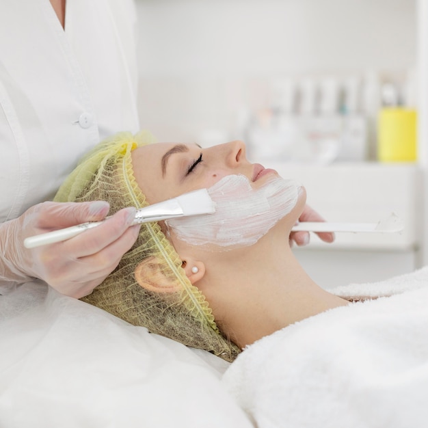 Woman at beauty clinic for face treatment