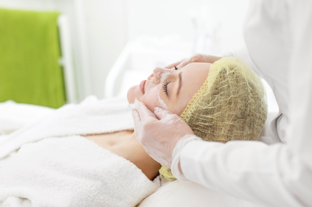 Woman at beauty clinic for face treatment