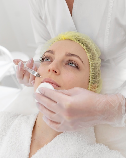 Woman at beauty clinic for filler treatment