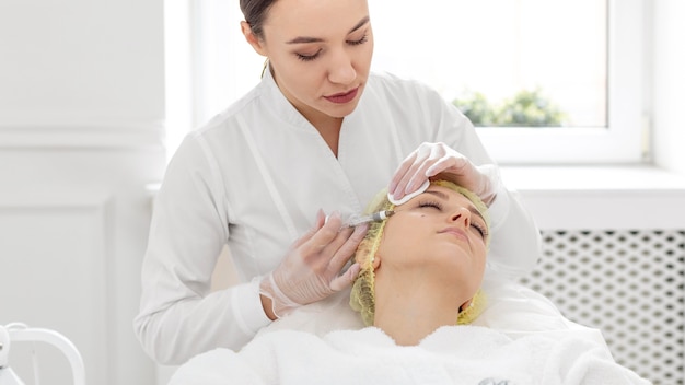 Woman at beauty clinic for filler treatment