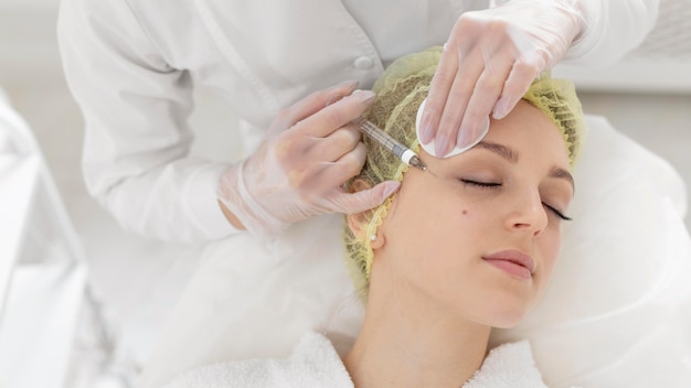 Woman at beauty clinic for filler treatment