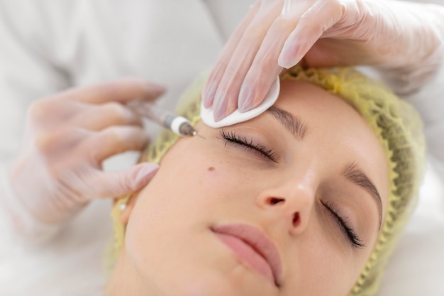 Woman at beauty clinic for filler treatment