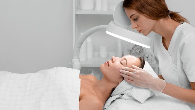 Woman at beauty salon for face treatment