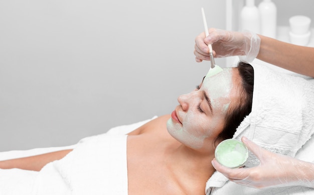 Woman at beauty salon for face treatment