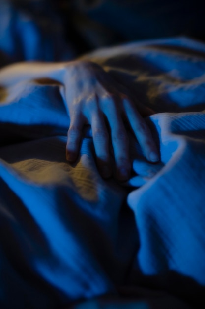 A hand on a sheet at anaddiction treatment center Idaho