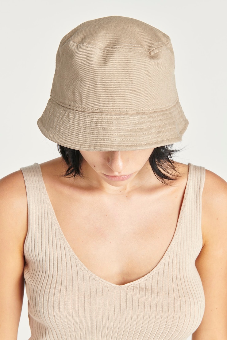 Free Photo woman in a beige bucket hat
