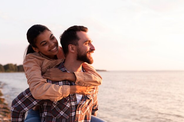 Woman being carried by her boyfriend with copy space