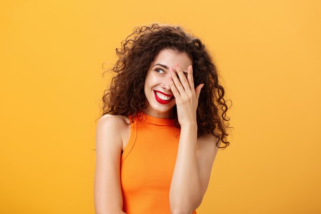 Woman being praised by coworkers feeling awkward and shy hearing congratulations with received award...