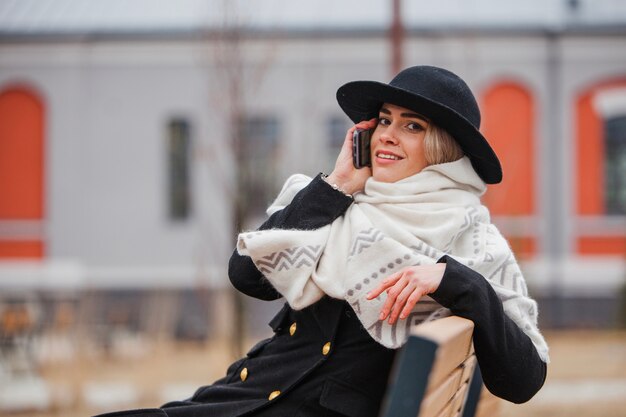 Woman on bench with smartphone