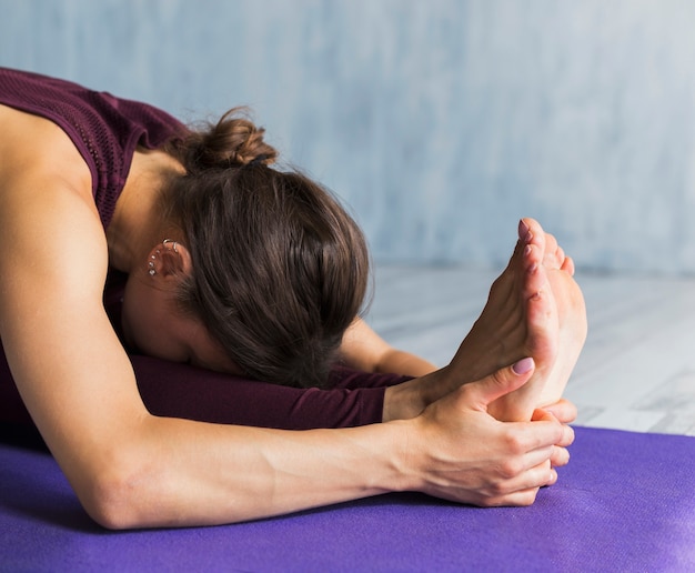 Woman bending over her feet