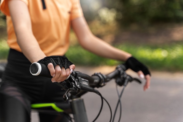 Free photo woman on bicycle side view