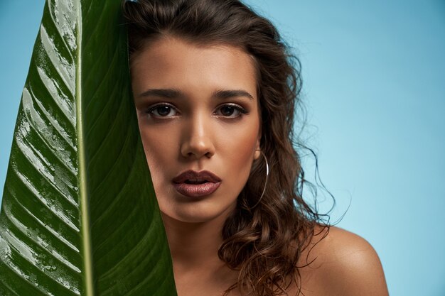 Woman and big green leaf isolated