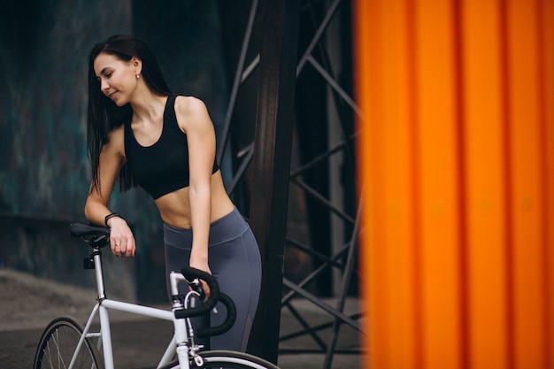 Free photo woman biking in city