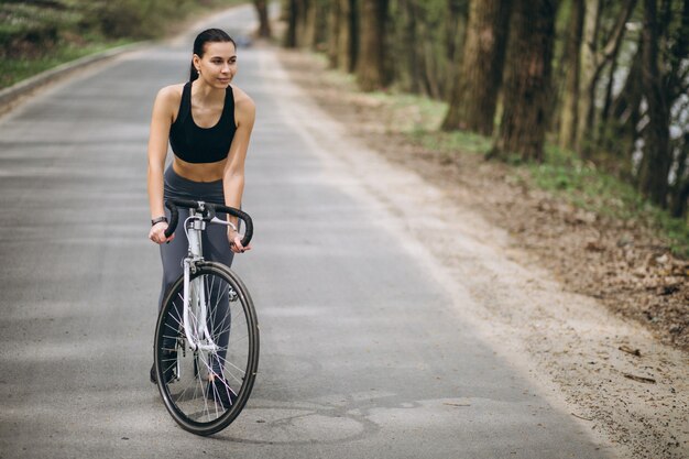 Woman biking in forest