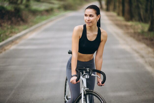 Woman biking in forest