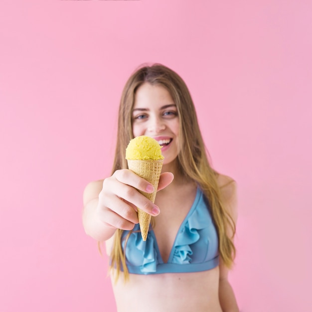 Woman in bikini showing ice cream
