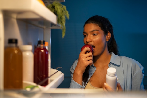 Woman biting apple front view