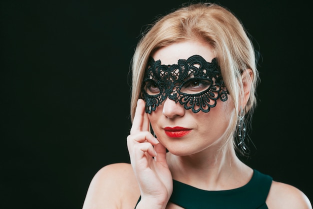 Woman in black carnival mask 
