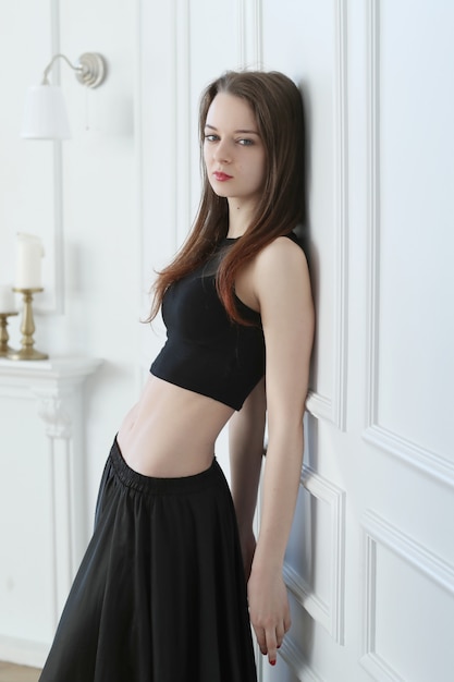 Woman in black crop top and long skirt