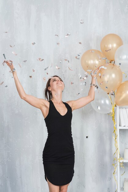 Woman in black dress on party