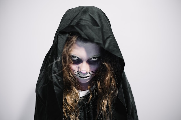 Free photo woman in black hood and face paint