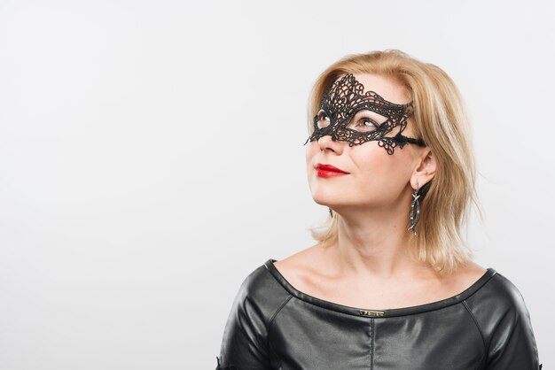 Woman in black mask looking away