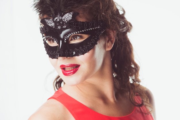 Woman in black mask posing in studio