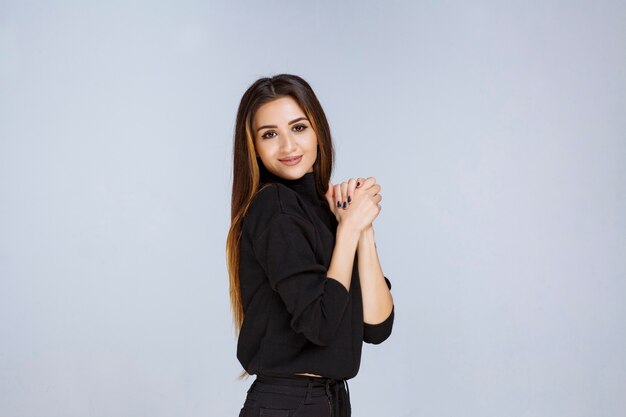 woman in black shirt giving appealing and neutral poses. 
