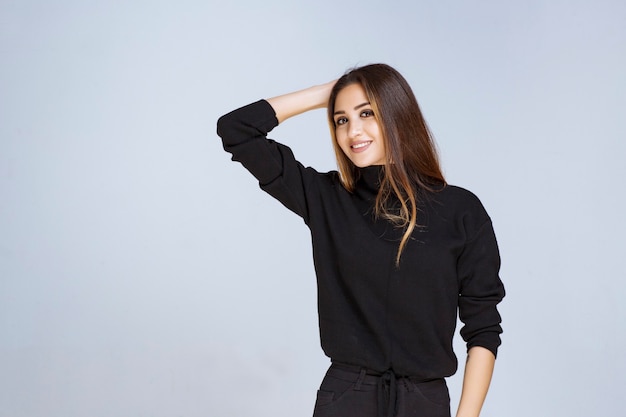 woman in black shirt giving appealing and neutral poses. 