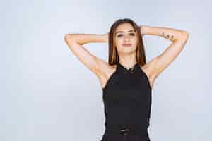 Free photo woman in black shirt giving positive and seductive poses.