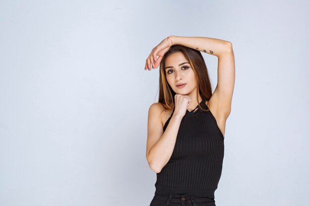 Woman in black shirt giving seductive and appealing poses. 