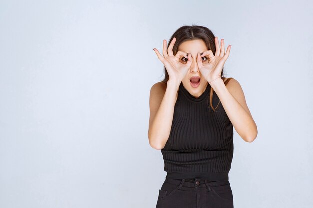 Woman in black shirt looking forward. 