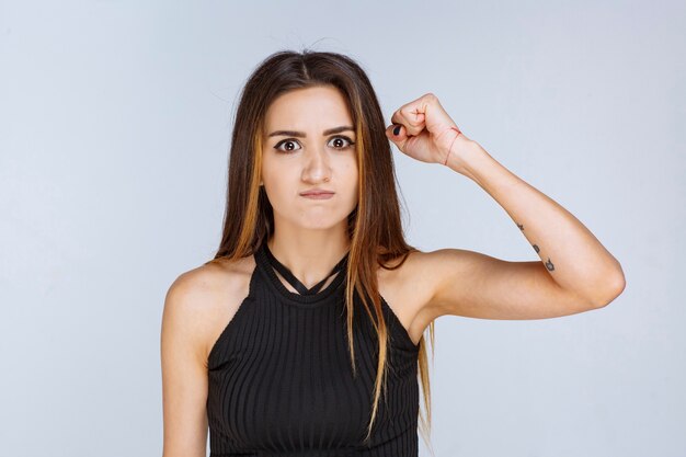 Woman in black shirt looks agressive and upset. 