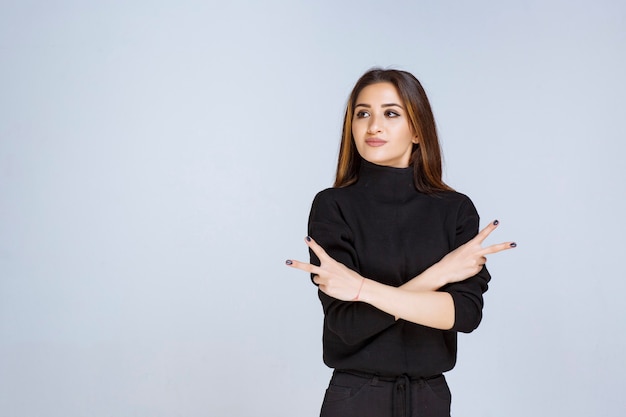 woman in black shirt sending peace and friendship message. 