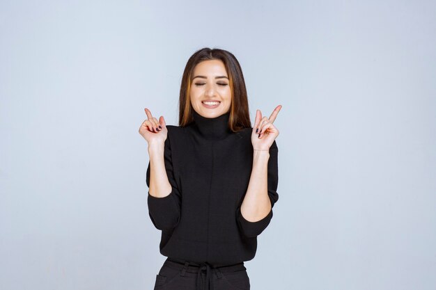 woman in black shirt sending peace and friendship message. 